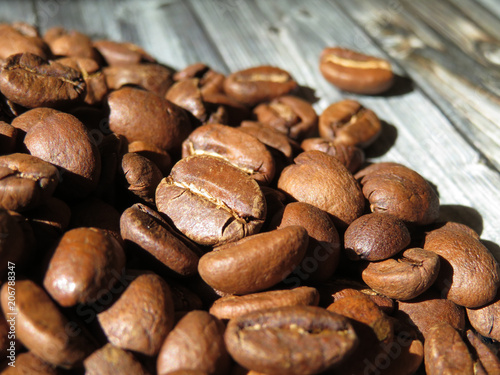 Roasted coffee beans on a wooden table, selective focus
