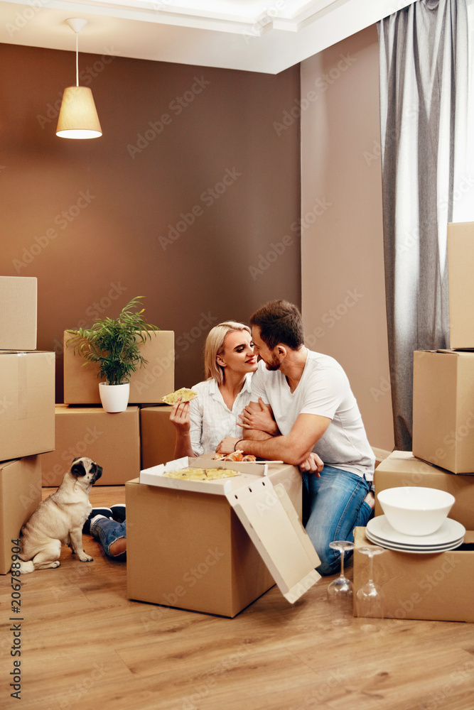 Moving. Man And Woman Eating Near Boxes Moving. Man And Woman Eating Near Boxes