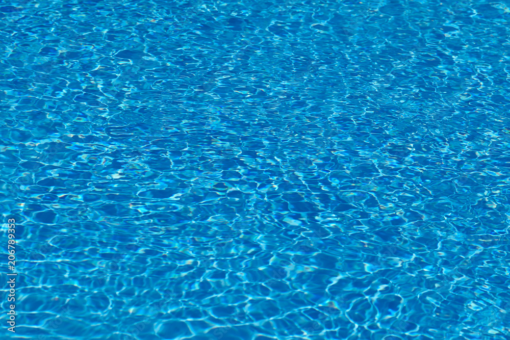 Ripple Water in swimming pool witn sun reflection