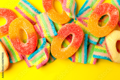 candies with jelly and sugar. colorful array of different childs sweets and treats. Bright party background..