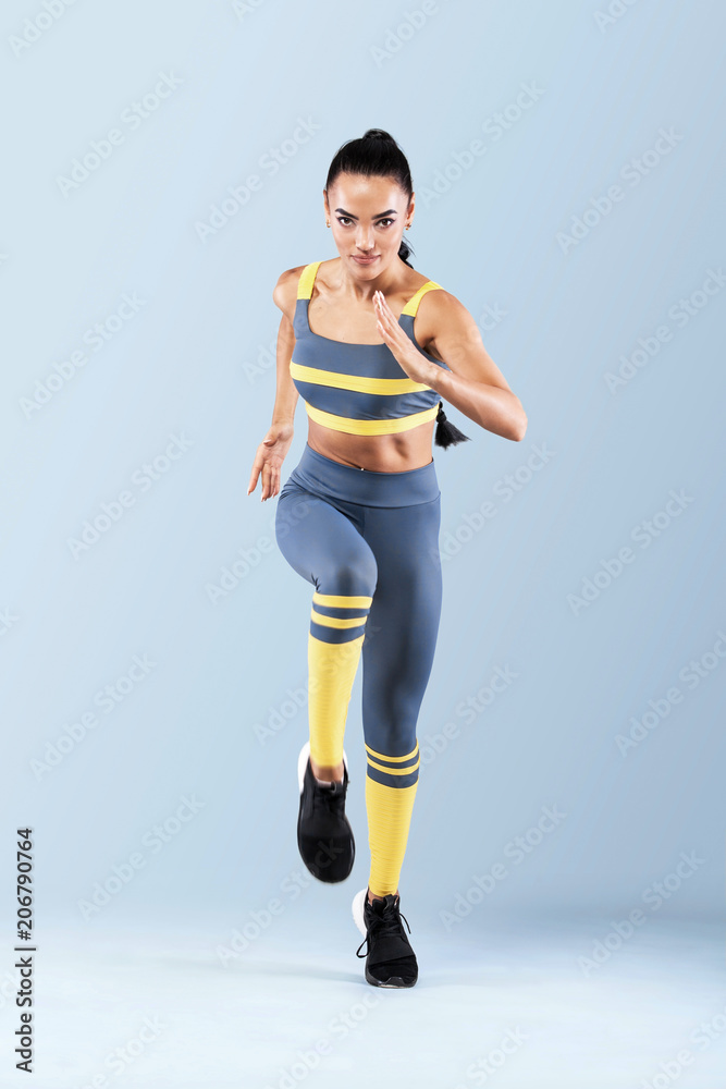 A strong athletic, women sprinter, running wearing in the sportswear,  fitness and sport motivation. Runner concept with copy space. Dynamic  movement Stock Photo by ©MikeOrlov 197435006