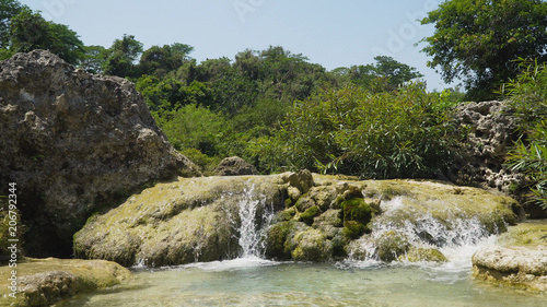 Waterfall in green rainforest. Bolinao waterfall in the mountain jungle. Philippines, Luzon. Travel concept.