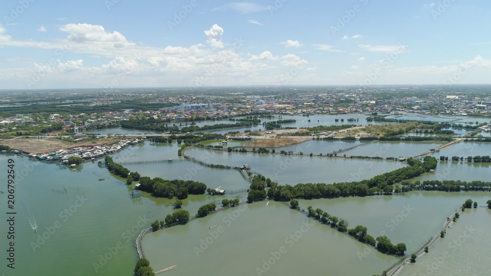 Town in cultivated mangroves, Ubagan, sto tomas. Fish farm with cages for fish and shrimp in the Philippines, Luzon. Aerial view of fish ponds for bangus, milkfish. Fish cage for tilapia, milkfish Town in cultivated mangroves, Ubagan, sto tomas. Fish farm with cages for fish and shrimp in the Philippines, Luzon. Aerial view of fish ponds for bangus, milkfish. Fish cage for tilapia, milkfish