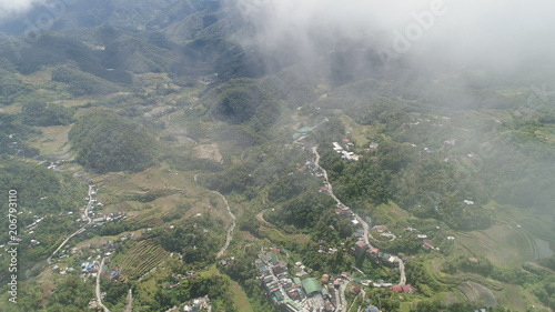 Aerial view of rice terraces on the slopes of the mountains, Banaue, Philippines. Rice cultivation in the North Batad. Mountains covered forest, trees. Philippine Cordilleras.