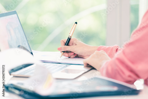 attractive businesswoman sitting working on laptop her small business from home