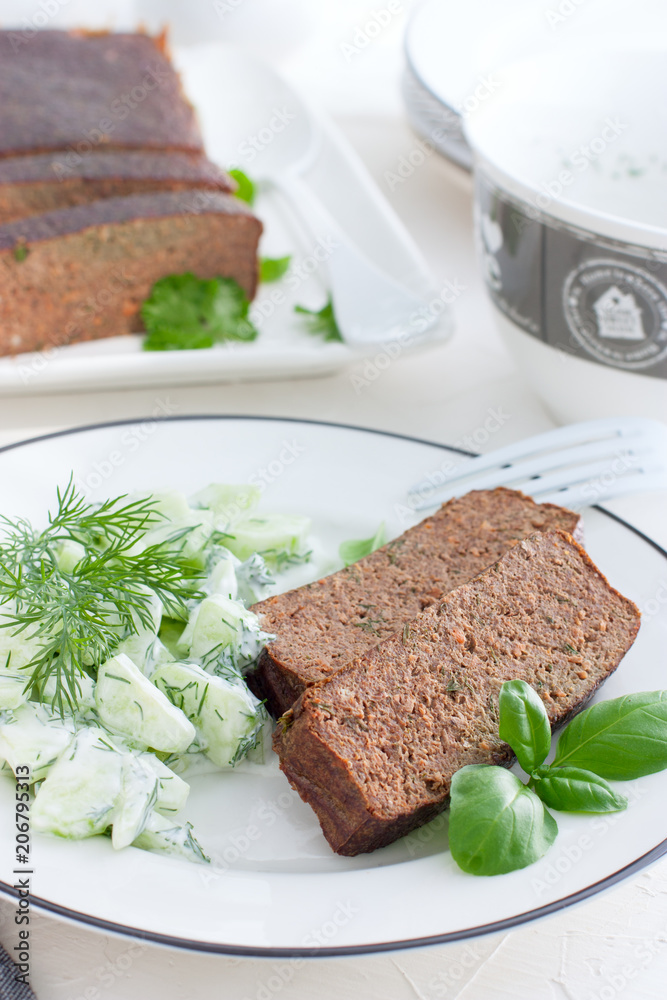 Snack plate with fresh salad from cucumbers and greens, pate from liver, selective focus