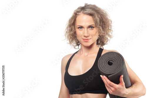 Fit woman with a gym mat