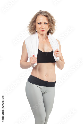 cheerful confident young woman with towel after gym