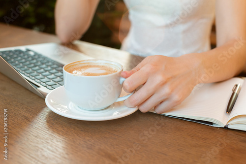 Woman using a laptop during a coffee break
