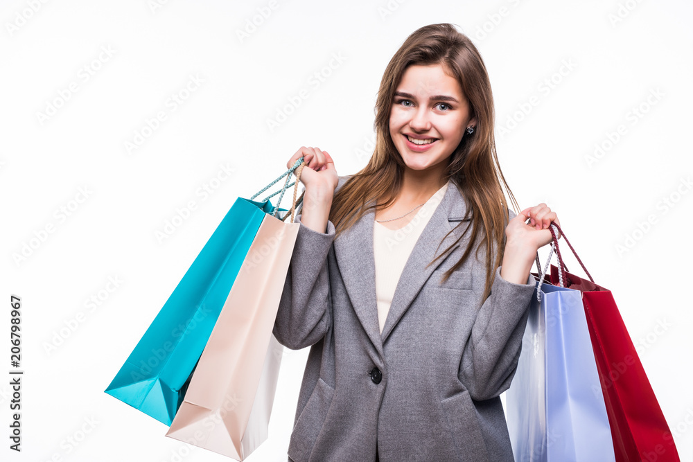 Portrait of young happy smiling woman with shopping bags isolated on white