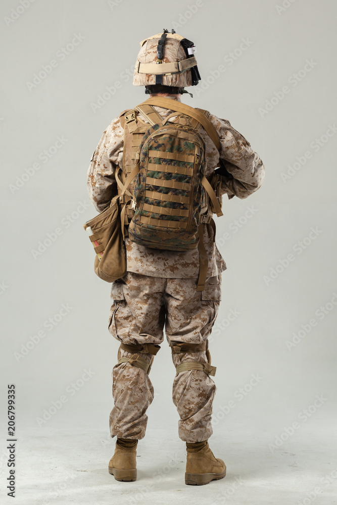 Soldier in camouflage holding rifle Soldier in camouflage holding rifle