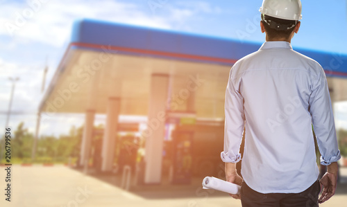 Business engineer planing at construction site with gas station background. Construction concept.