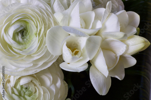 details of a wedding bouquet with white buttercups and white fresia