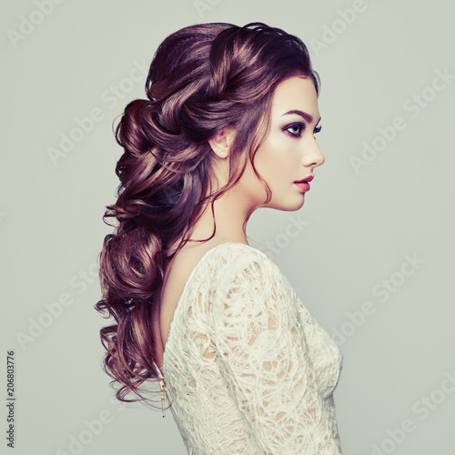 Brunette woman with long and shiny curly hair