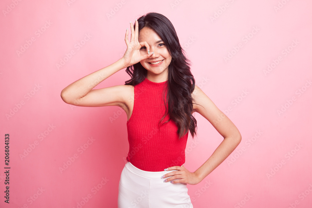 Beautiful young Asian woman show OK sign over her eye. Beautiful young Asian woman show OK sign over her eye.