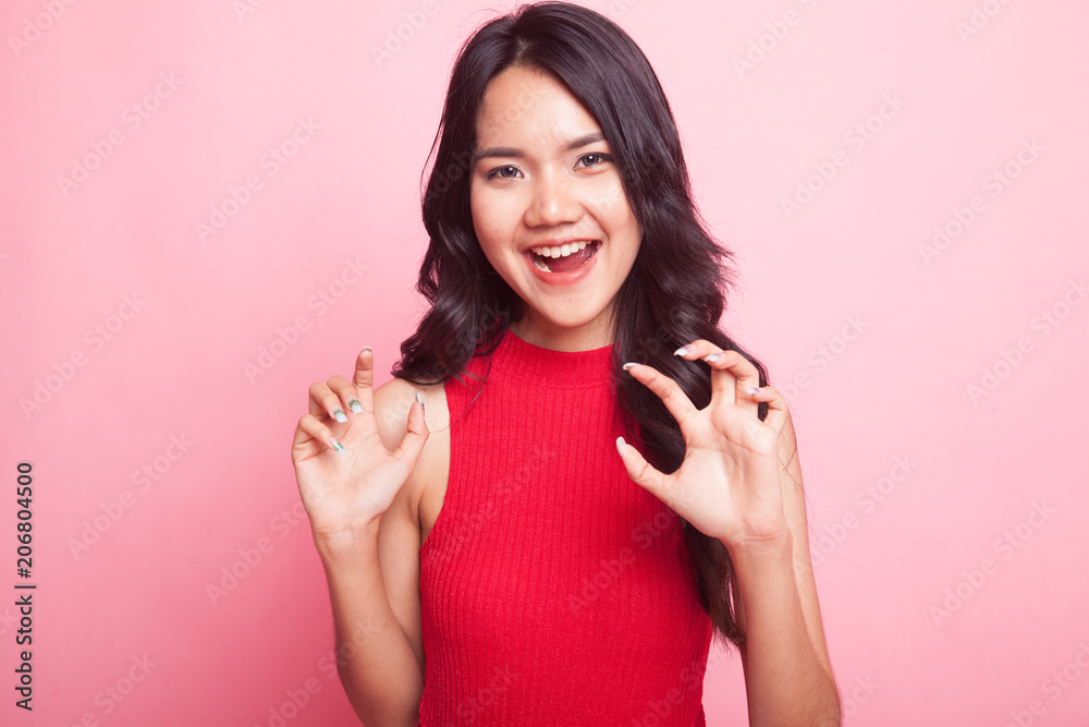 Young Asian woman with spooky hands gesture. Young Asian woman with spooky hands gesture.