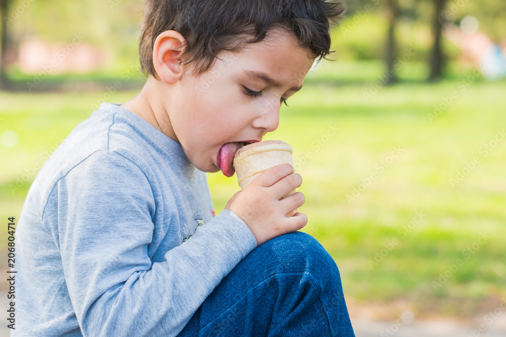 boy 4 years old licks ice cream boy 4 years old licks ice cream