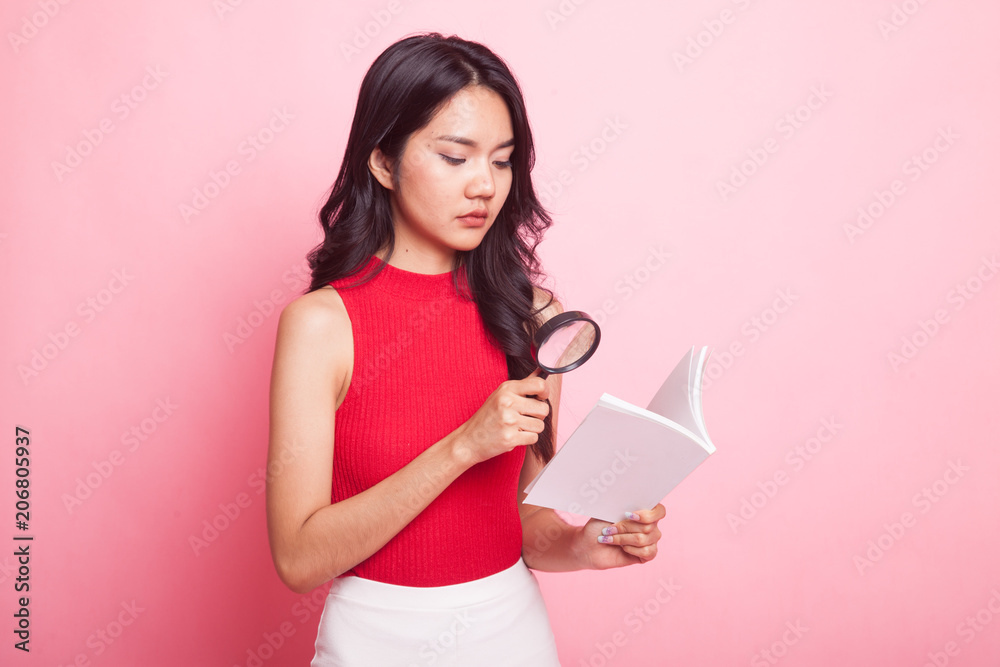 Asian woman with a book and magnifying glass. Asian woman with a book and magnifying glass.