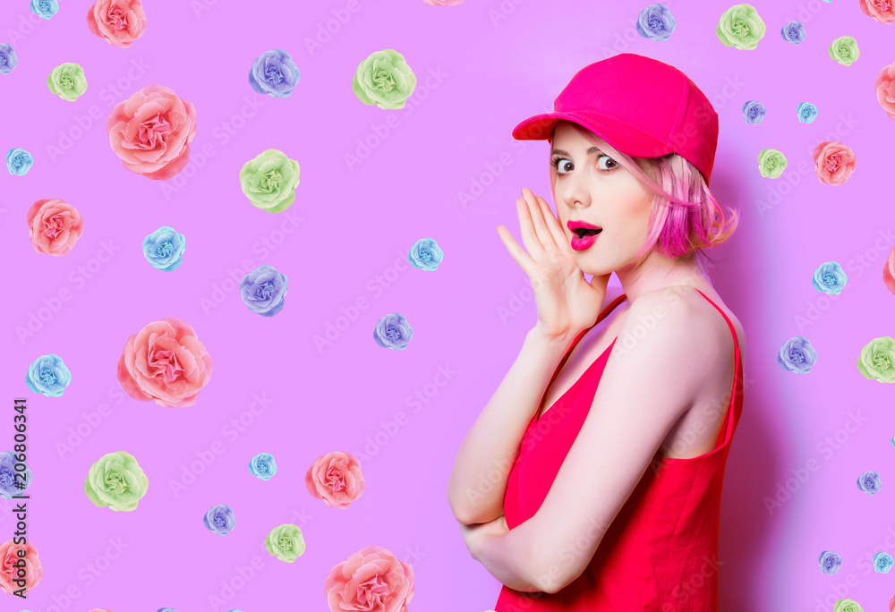 portrait of beautiful surprised young woman in cap with roses on the wonderful purple studio background portrait of beautiful surprised young woman in cap with roses on the wonderful purple studio background