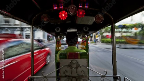 Time Lapse of a Speeding Rickshaw on the busy roads of Bangkok, Thailand, Asia photo