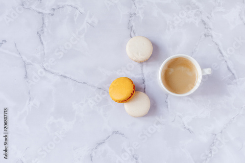 a cup of coffee with sweets on a gray marble background. Copy space. Selective focus.