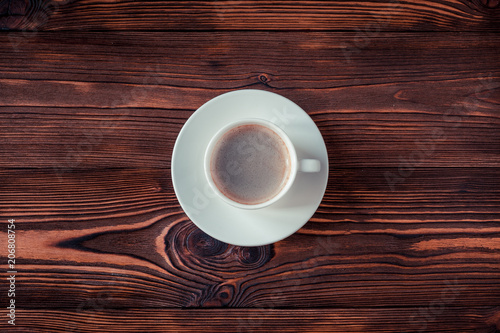 Cup of coffee on a wooden background. Copy space. Selective focus.