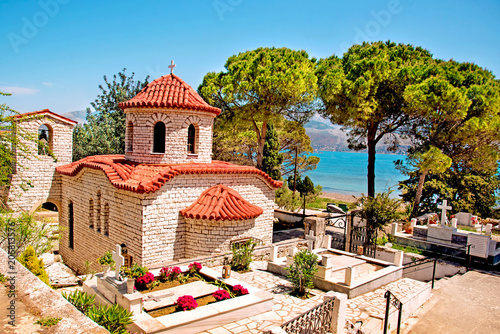 Beautiful landscape with an ancient church at the cemetery near the sea in Argostoli, Kefalonia, Greece.  Stunning amazing charming places. prominent tourist towns. photo