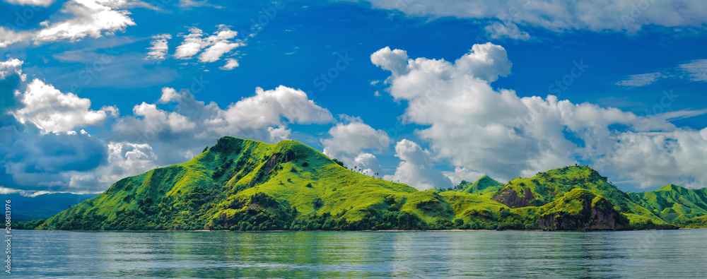 Panorama of a green hilly island near the island of Flores (Indonesia) - obrazy, fototapety, plakaty 