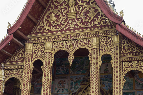 front view and detail of a pagoda in Luang Prabang in Laos