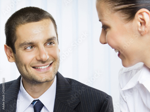 Two smiling young businesspeople photo