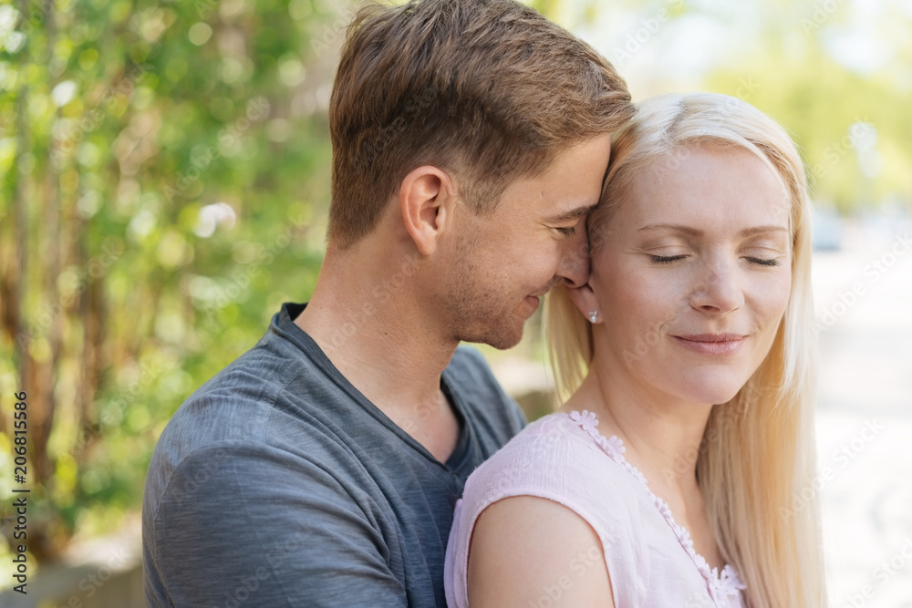 Happy contented couple sharing a loving moment Happy contented couple sharing a loving moment