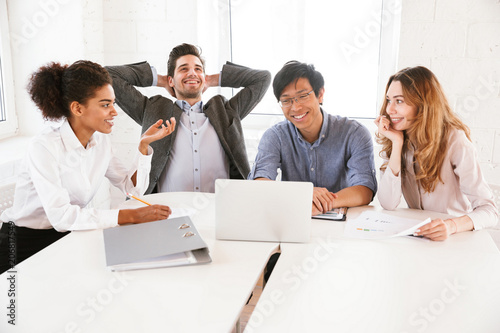 Group of smiling young multiethnic businesspeople