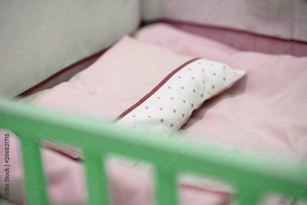 Empty pink tone baby crib
