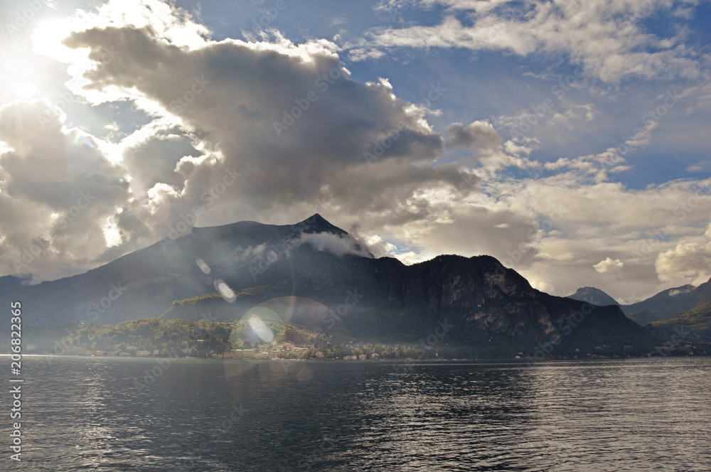 View of Lake Como in a cloudy day with sunshine in Bellagio, a charming tourist village between the lake and the mountains of the Alps. Located in the Lombardy region, northern Italy View of Lake Como in a cloudy day with sunshine in Bellagio, a charming tourist village between the lake and the mountains of the Alps. Located in the Lombardy region, northern Italy