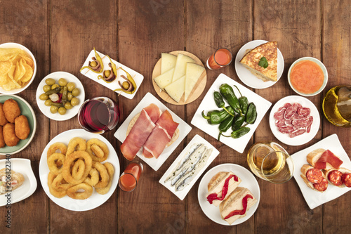 Spanish tapas food on dark background with wine and place for text