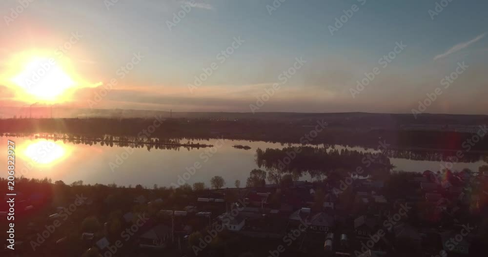 Aerial view of village and lake at sunset. 4K Aerial view of village and lake at sunset. 4K