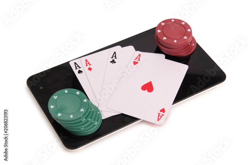 Playing cards and chips with a tablet on a white background