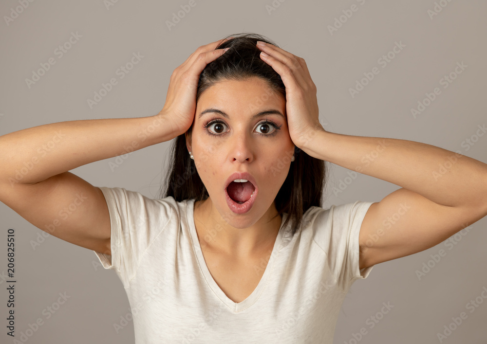 Young attractive woman with a surprised and shocked face, eyes and mouth wide open. Young attractive woman with a surprised and shocked face, eyes and mouth wide open.