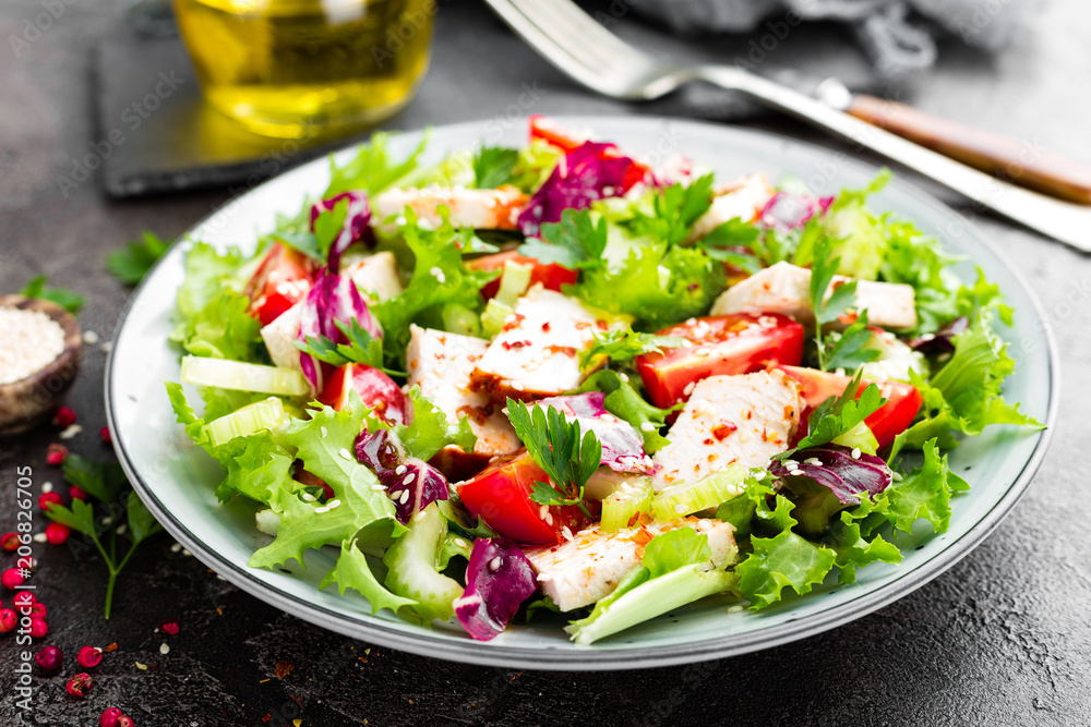 Meat salad with fresh vegetables. Vegetable salad with baked chicken breast. Vegetable salad with chicken fillet on plate Meat salad with fresh vegetables. Vegetable salad with baked chicken breast. Vegetable salad with chicken fillet on plate