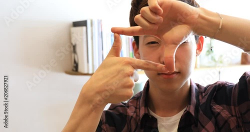 Asian young man making frame with his hands