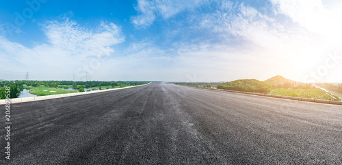 Empty asphalt highway under the blue sky panoramic view