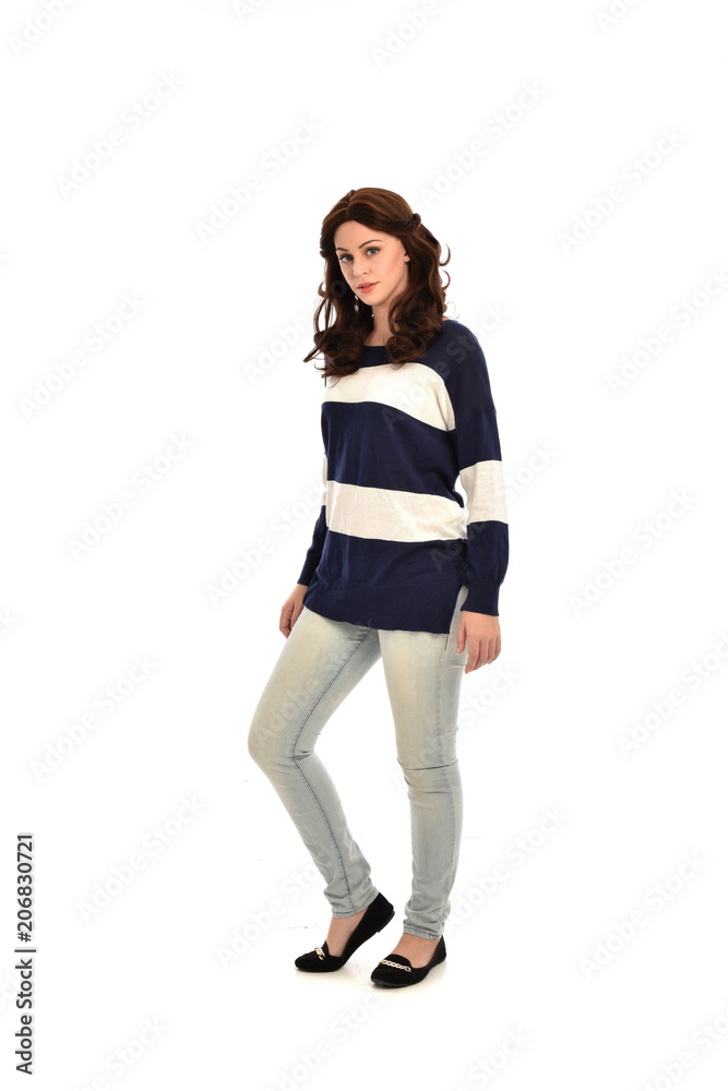 full length portrait of girl wearing striped blue and white jumper and jeans. standing pose on white studio background full length portrait of girl wearing striped blue and white jumper and jeans. standing pose on white studio background