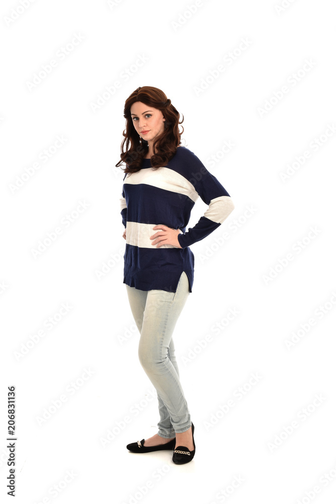 full length portrait of girl wearing striped blue and white jumper and jeans. standing pose on white studio background full length portrait of girl wearing striped blue and white jumper and jeans. standing pose on white studio background