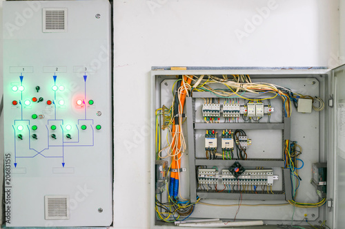 The backup power management system is located next to the open electrical panel. Electric box with lots of automatons and voltage relays.