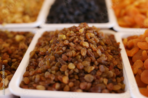 Raisins, dried fruits, on the market counter.
