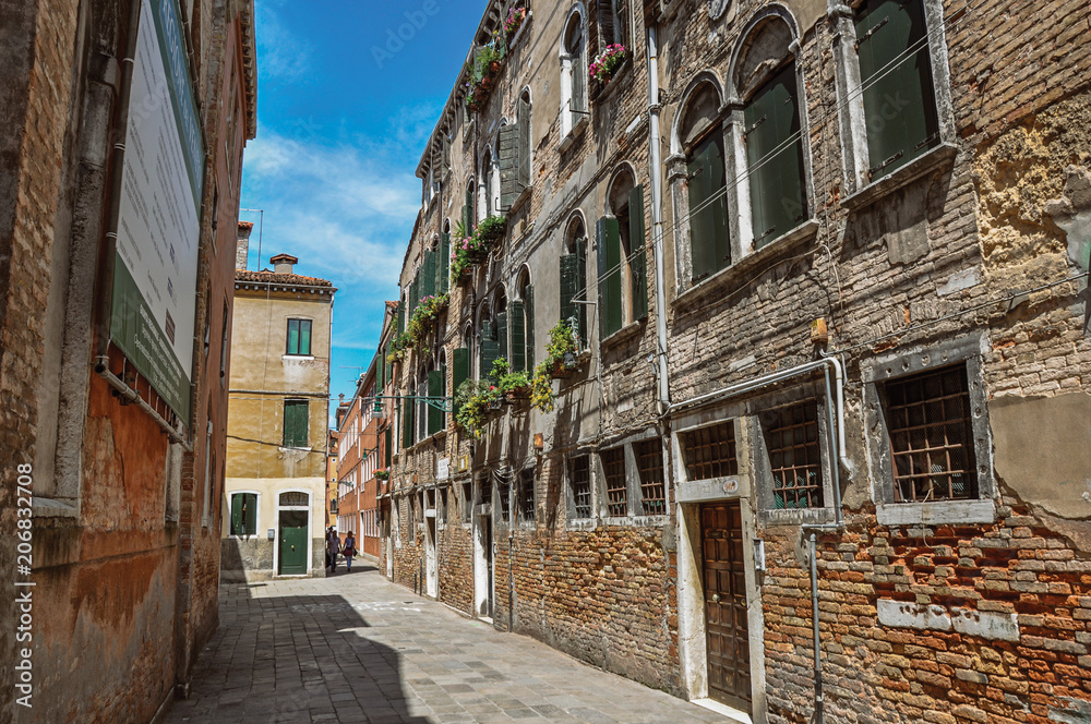 View of old buildings in an alley with blue sky in the city center of Venice, the historic and amazing marine city. Located in Veneto region, northern Italy