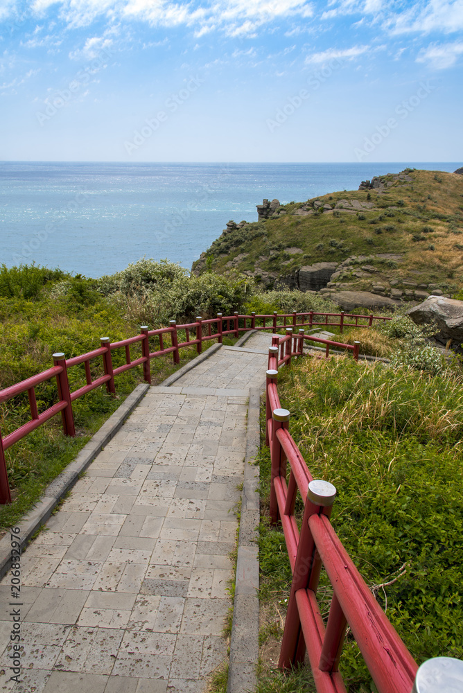 Hiking trail with ocean view, Jeju island, South Korea.