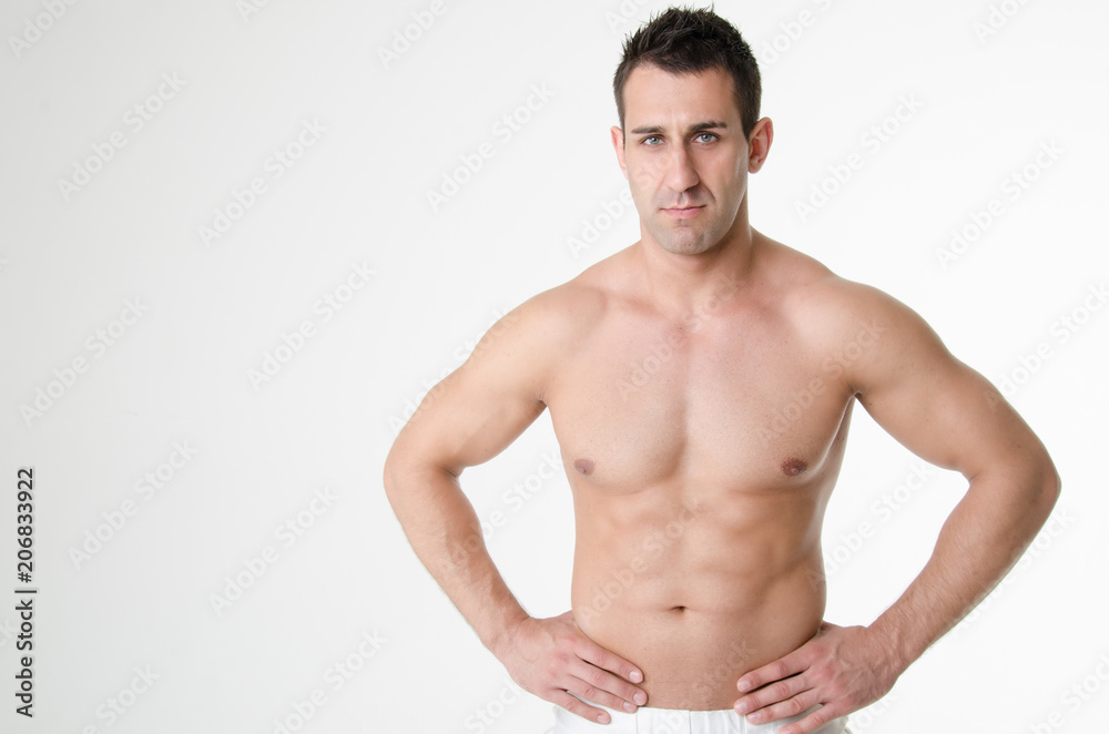 Sexy athletic man. Gray background. 