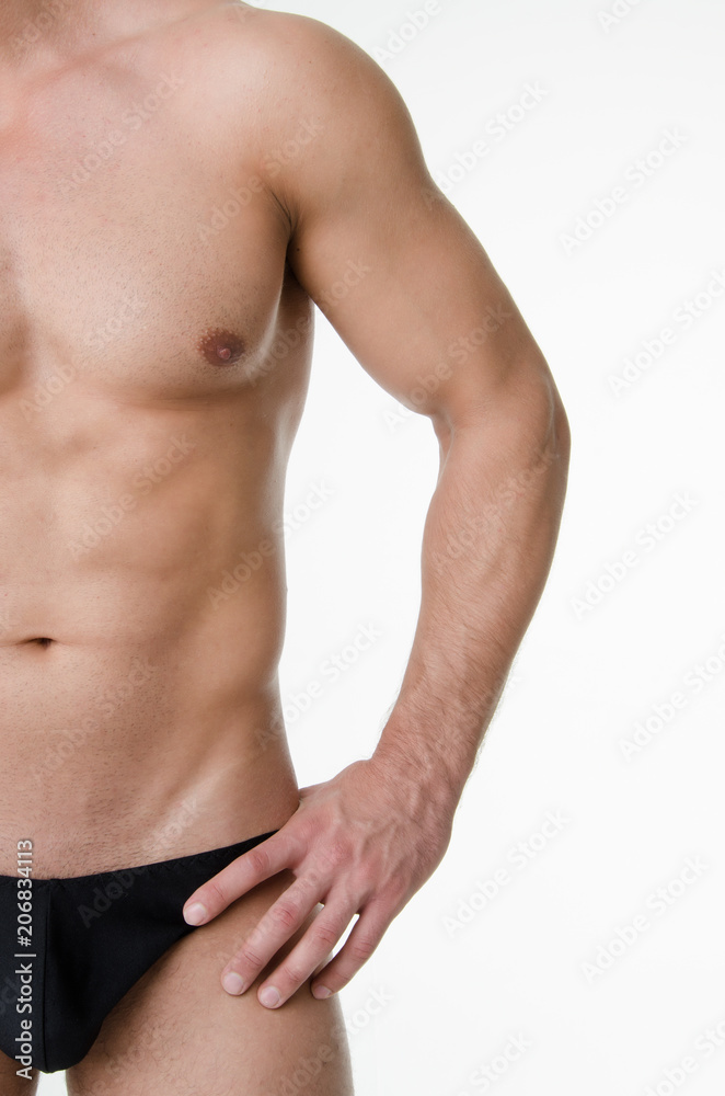 Sexy athletic man. Gray background. 