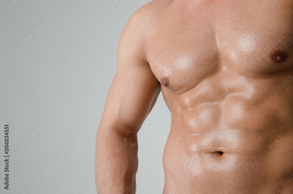 Fototapeta premium Sexy athletic man. Gray background. 